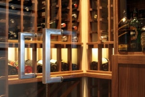 Handles on Frameless Glass Doors into Custom Wine Cellar